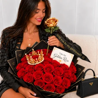 Woman smelling a golden rose from a Will you be my girlfriend red roses bouquet with gold crown, black wrapping and Take the Golden Rose card – Frutidetails Miami