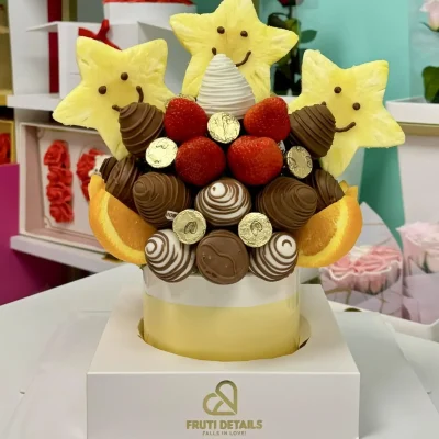 Classic fruit bouquet with smiling pineapple stars, chocolate-covered strawberries, and orange slices — handcrafted by Frutidetails Miami